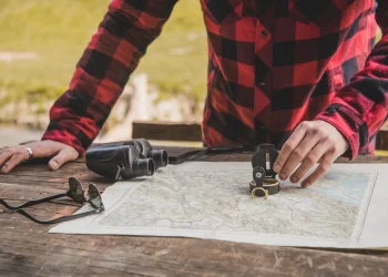 close-up-hand-with-compass-map